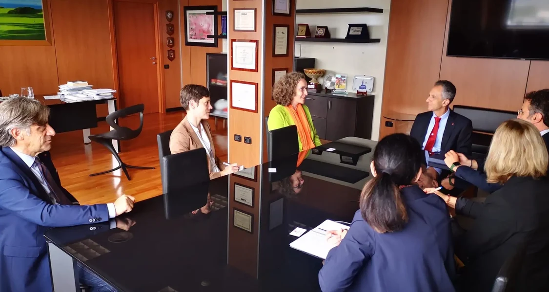 Seven Persons sitting on a table in a great looking office inside the University of Calabria