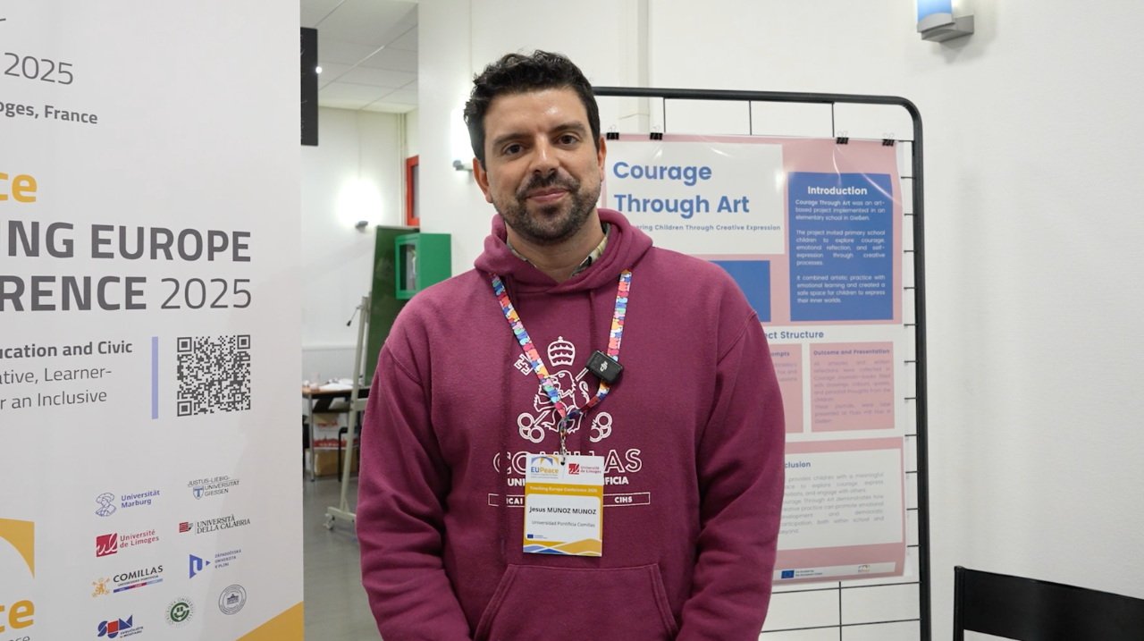 A person standing in front of banners for the EUPeace Teaching Europe Conference 2025. The person is Jesús Muñoz Muñoz.