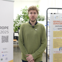 A person standing in front of banners for the EUPeace Teaching Europe Conference 2025. The person is Leon Hebeisen.