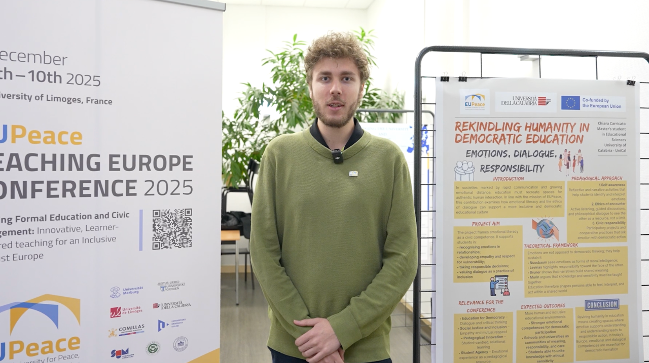 A person standing in front of banners for the EUPeace Teaching Europe Conference 2025. The person is Leon Hebeisen.