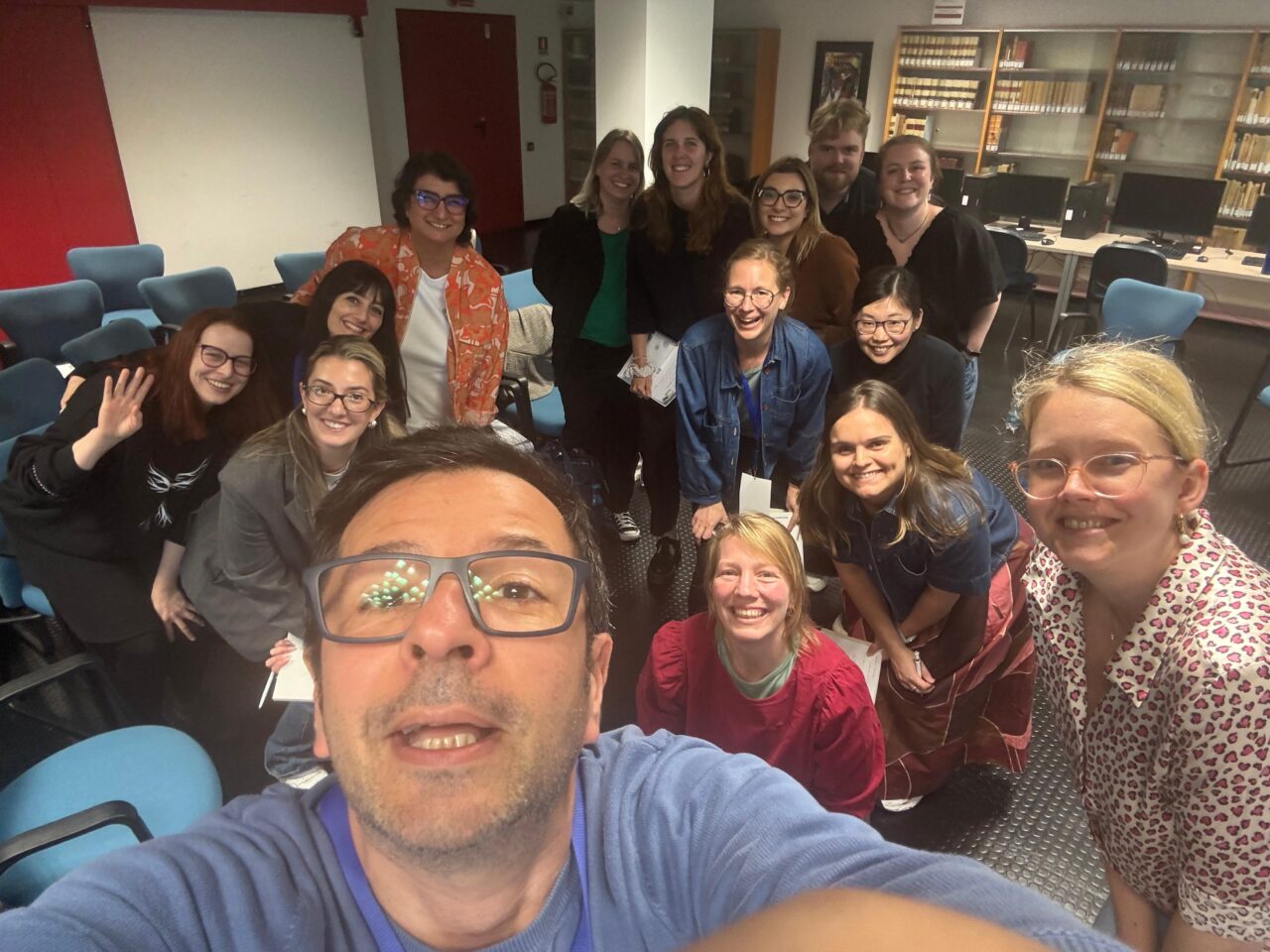 A group of people posing for a selfie. A man is taking the picture.