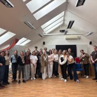 The group of EUPeace BIP participants and organisers poses for a group photo in a bright attic room at the Faculty of Education, UWB Pilsen.