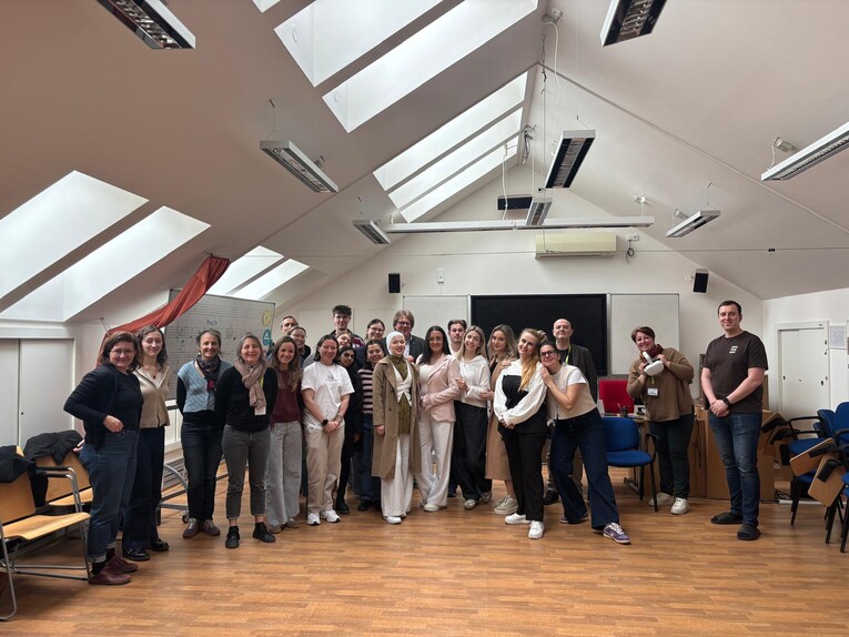 The group of EUPeace BIP participants and organisers poses for a group photo in a bright attic room at the Faculty of Education, UWB Pilsen.