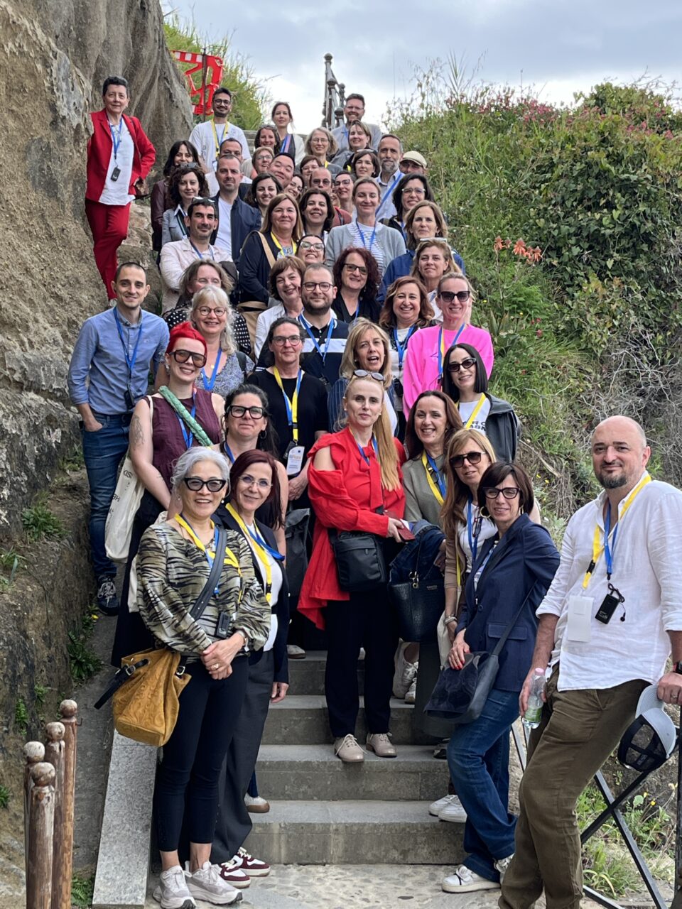 Participants of the event posing for a group photo, standing on steps.