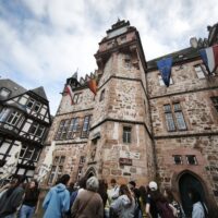 A group of pre-service teachers and colleagues from the University of Limoges, standing in front of the Town Hall of Marburg, Germany.