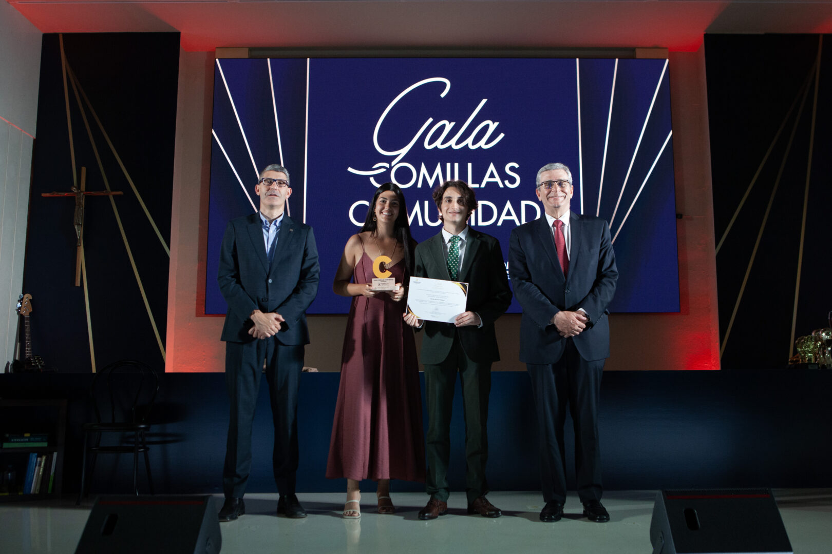 Student from the EUPeace Comillas Club receives the Most Committed Student Association award on stage at the IV Comillas Community Gala.