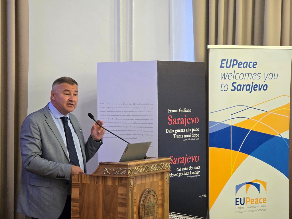 A person standing behind a podium, speaking into the microphone. The person is Vice-Rector for International Cooperation Prof. Kemal Durić.