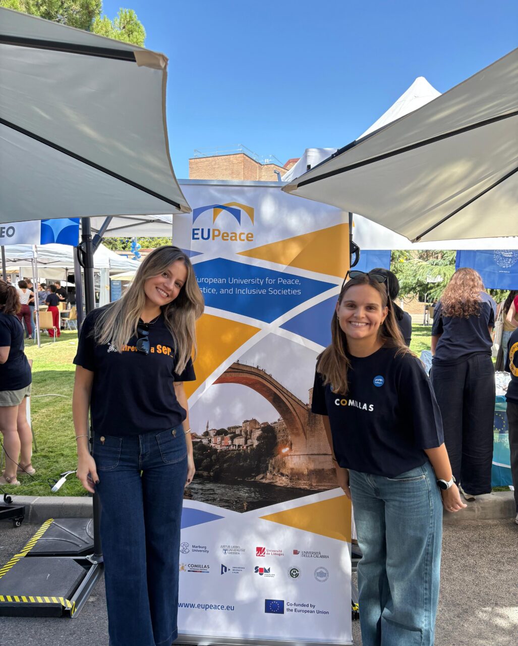 Members of the EUPeace Comillas team pose in front of the EUPeace banner at Welcome Day.