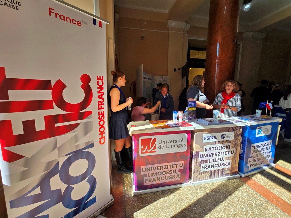 Exhibition stands of the Université de Limoges, the Catholic University of Lille and UTBM next to a large “Choose France” banner.