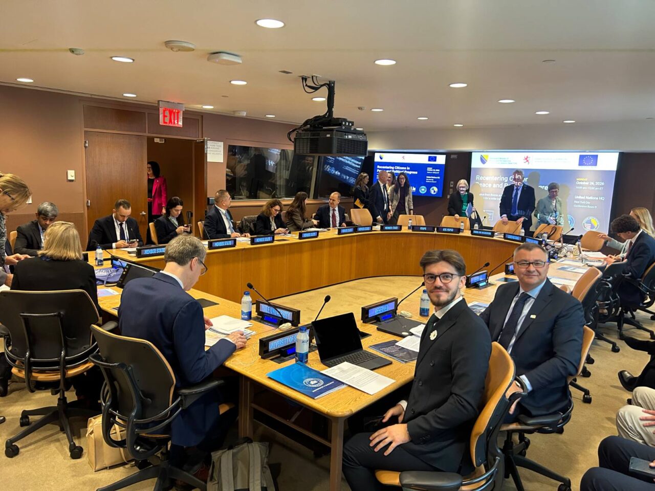 Participants gather around a conference table at the United Nations Headquarters in New York.