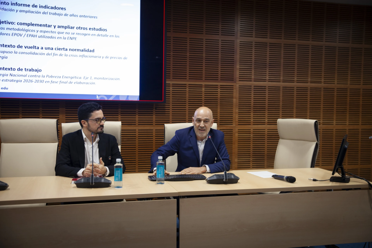 Two speakers from the Chair of Energy and Poverty standing at the front of the room, presenting the findings of the 2024 Energy Poverty Report.