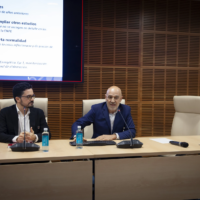 Two speakers from the Chair of Energy and Poverty standing at the front of the room, presenting the findings of the 2024 Energy Poverty Report.