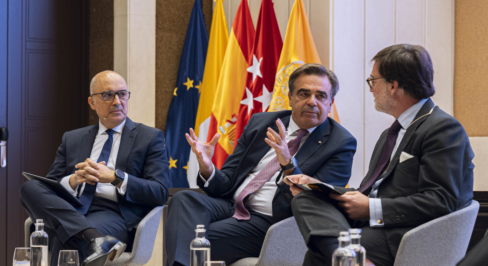 Francisco Javier Sánchez Segura, Margaritis Schinas, and Emilio Sáenz-Francés sit on a stage at Comillas Pontifical University during the presentation of the Chair on Strategic Autonomy Studies, on October 23, 2025.