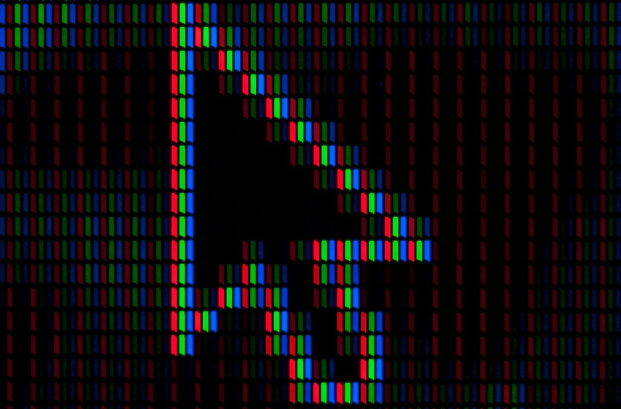 A digital arrow behind black background with blue, green, and red pixels.
