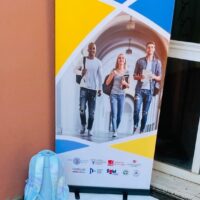 Banner of the EU PEACE project displayed at the University of Calabria during the European Researchers’ Night 2025, with student imagery and project logos.