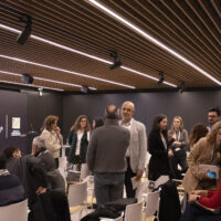 Participants standing and talking during a networking break at EnerPeace 2026.