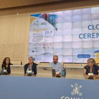 Panel of speakers at Comillas University presenting during an academic event.