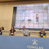 Panel of speakers at Comillas University presenting during an academic event.