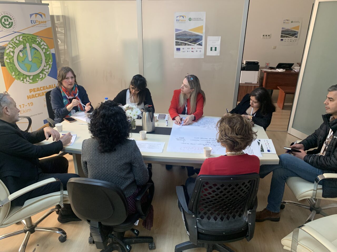 A group of professionals discussing policy recommendations during a joint working group meeting on future vision.
