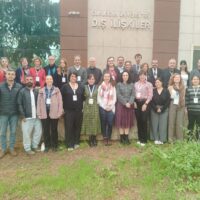 Participants of the European Universities Türkiye Workshop posing for a group photo outside a university building.