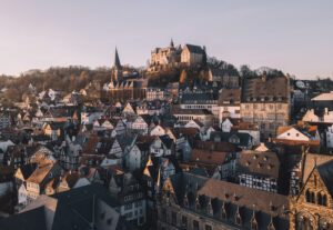 Half-timbered houses with a Castle on a hill in the background