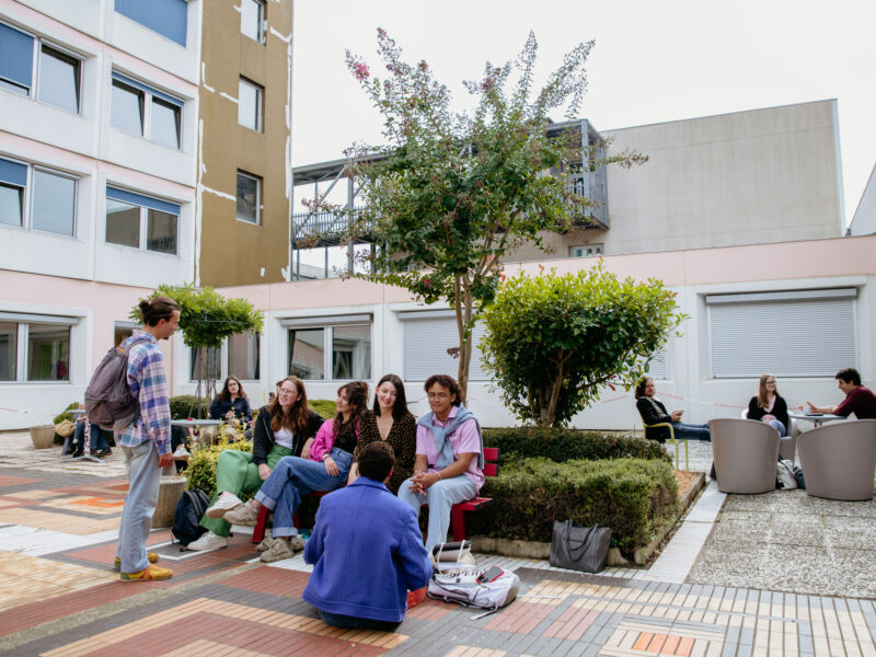 Students gathered and chatting in a courtyard on the University of Limoges campus.