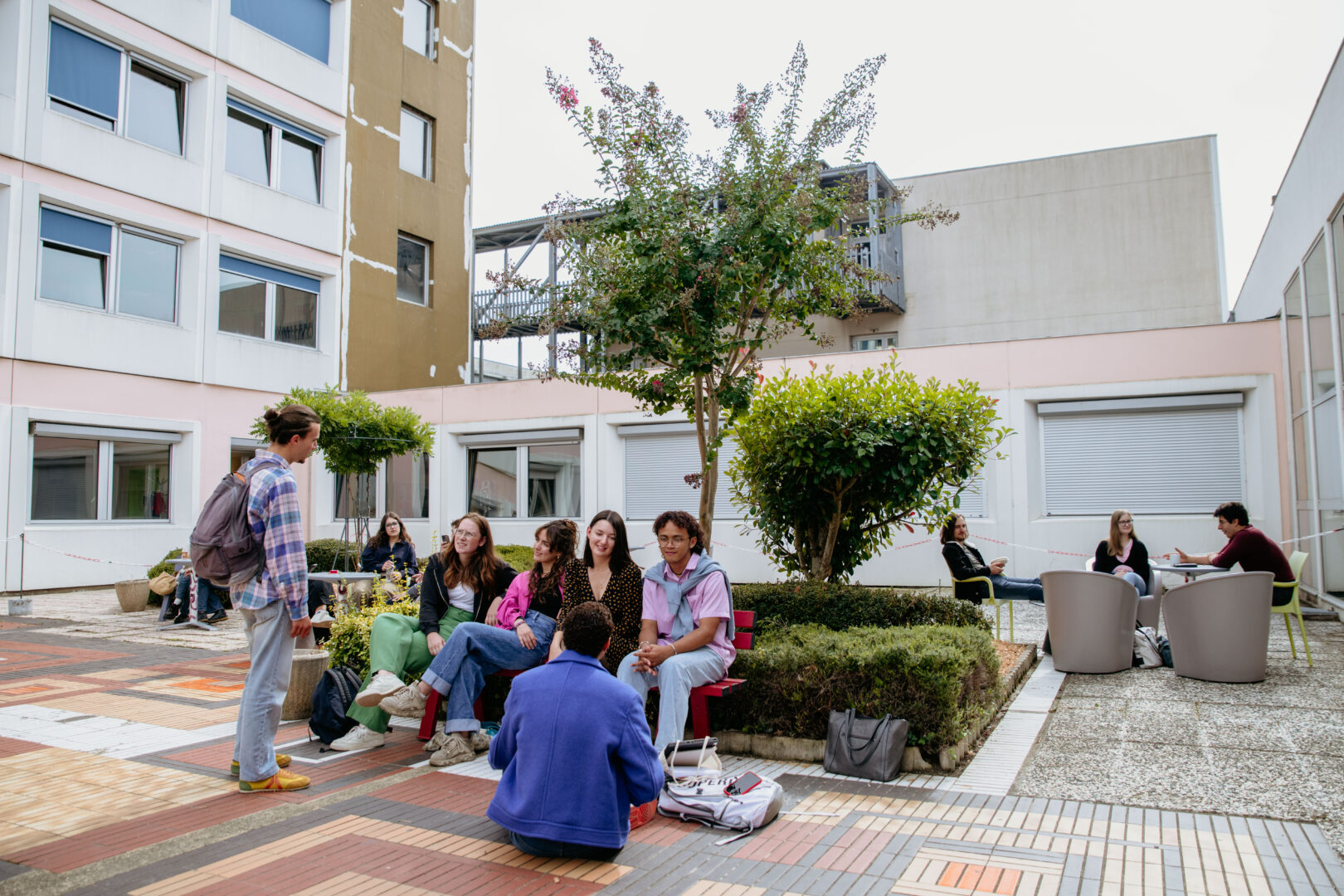 Students gathered and chatting in a courtyard on the University of Limoges campus.