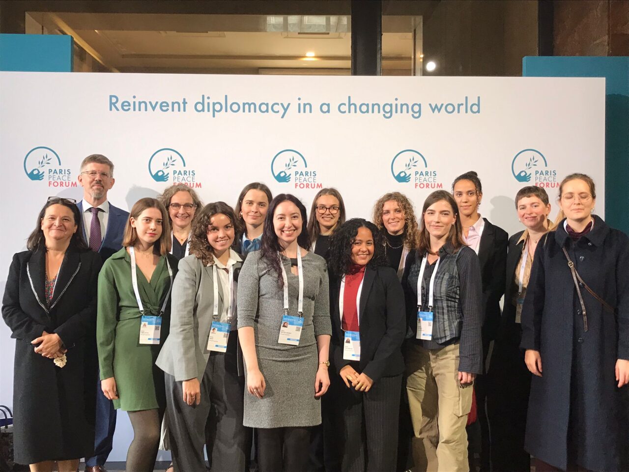 A diverse group of people representing the EUPeace delegation at the Paris Peace Forum 2025.