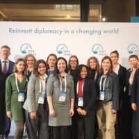 A diverse group of people representing the EUPeace delegation at the Paris Peace Forum 2025.