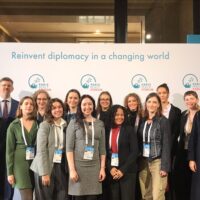 A diverse group of people representing the EUPeace delegation at the Paris Peace Forum 2025.