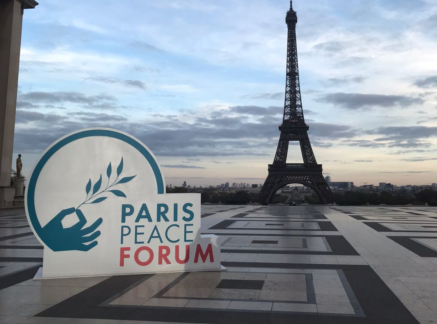 The logo of the Paris Peace Forum 2025 in front of the Eifel Tower.