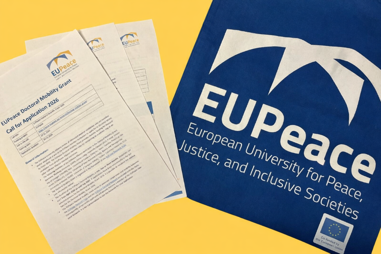 Application documents for the EUPeace Doctoral Mobility Grant 2026 on the left, a bag with the EUPeace logo on the right.